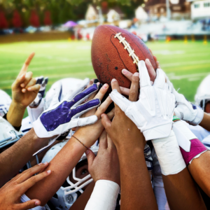 Photo of high school sports athletes celebrating a win after a football game in Merrill, Wisconsin.