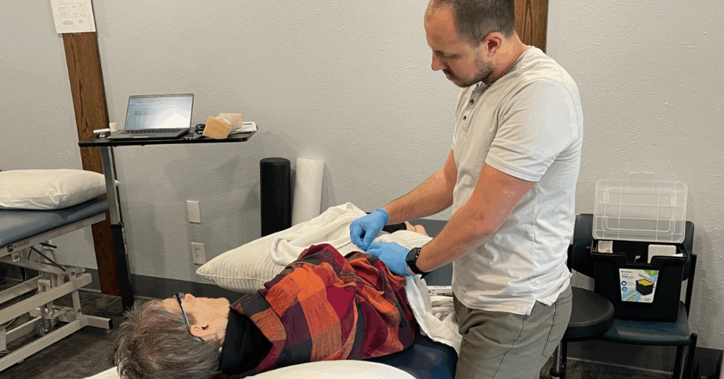 Mike Mathson at Merrill Physical Therapy, a licensed Dry Needling Therapist, is using dry needling techniques on a patient in Merrill, WI