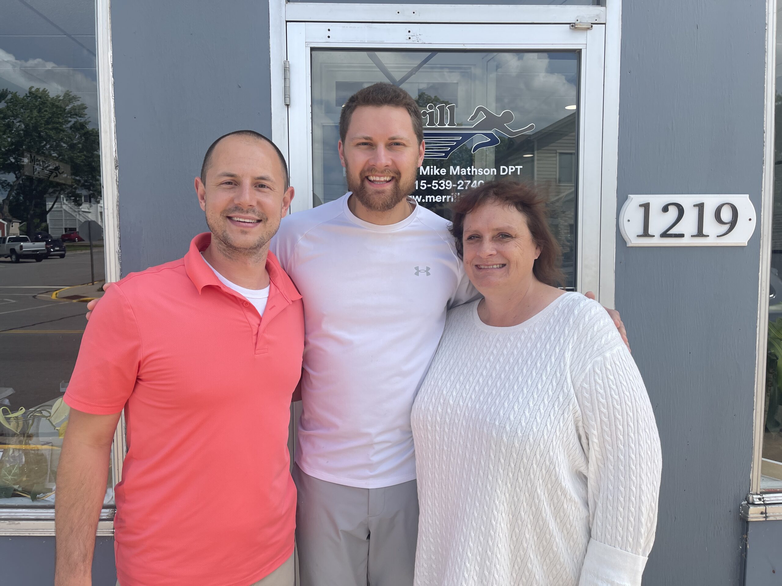Photo of Mike Mathson, Josiah Kukulka, and Stacy Roesler in front of Merrill Physical Therapy in Merrill, WI. Merrill PT specializes in physical therapy and orthopedic injuries, including dry needling, ASTYM, and manual therapy.